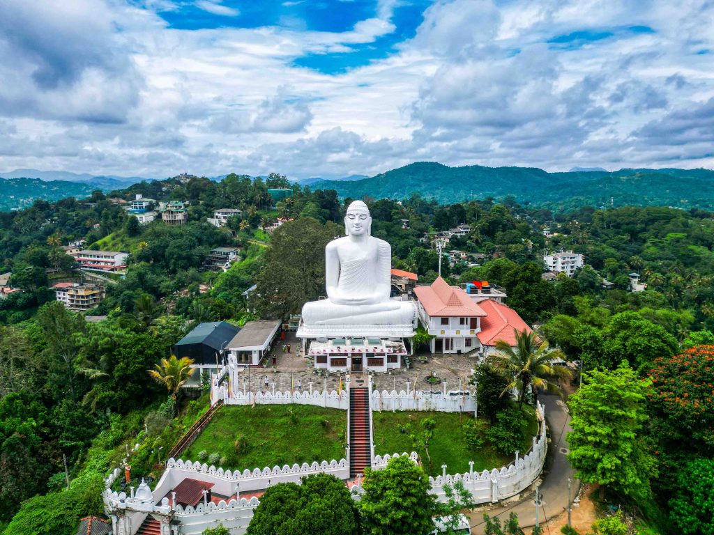 Bahirawakanda Sri Maha Bodhi Viharaya is a Theravada Buddhist Temple in Kandy, Sri Lanka. Top aerial drone view of giant white Buddha statue