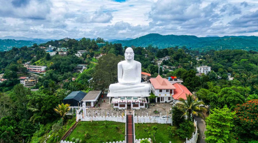 WHITE_BUDDHA_KANDY Bahirawakanda Sri Maha Bodhi Viharaya is a Theravada Buddhist Temple in Kandy, Sri Lanka. Top aerial drone view of giant white Buddha statue