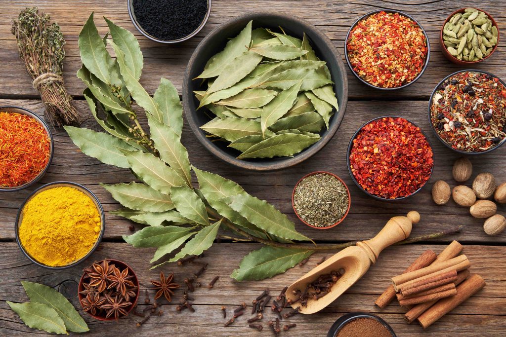 A vibrant assortment of Sri Lanka’s world-famous spices, including Ceylon cinnamon, turmeric, cloves, nutmeg, cardamom, and dried chili, 